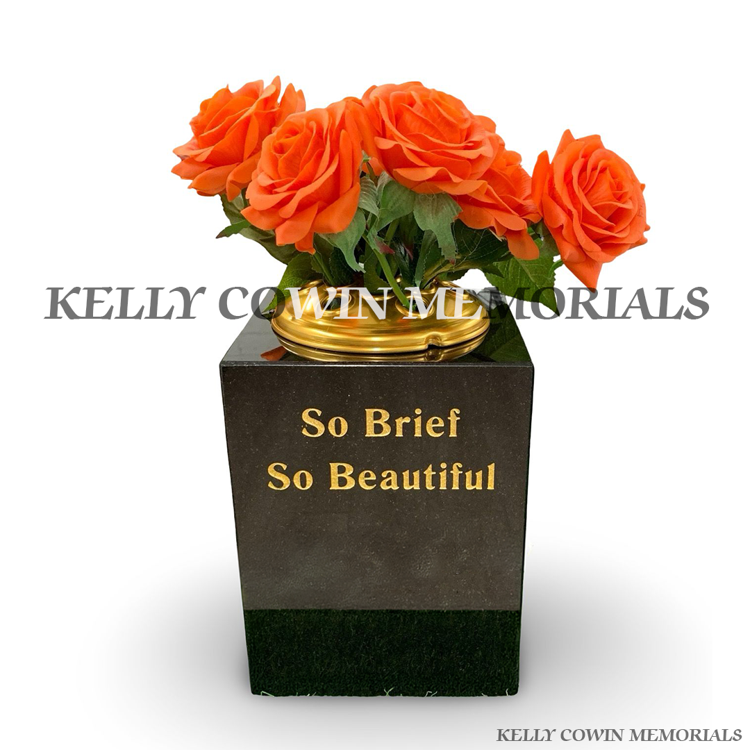 Front view of black granite square vase with gold lid and gold inscription