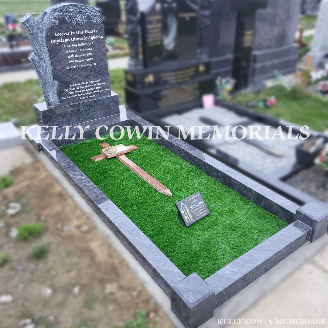 Side view of Blue Lagoon headstone showing antique carving and full granite kerbing in Bohernabreena Cemetery