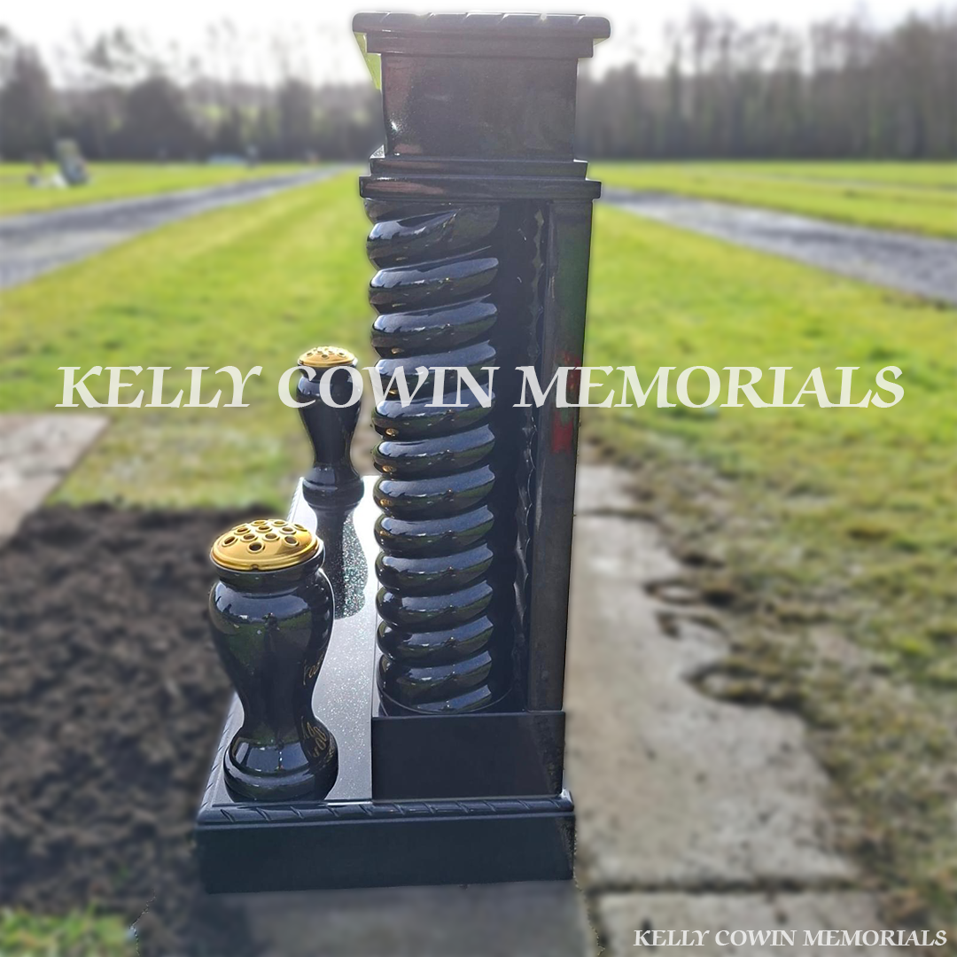 Side view of a black granite broken heart headstone with twisted pillars and gold leaf inscription, installed by Kelly Cowin Memorials in Newlands Cross Cemetery, Dublin.