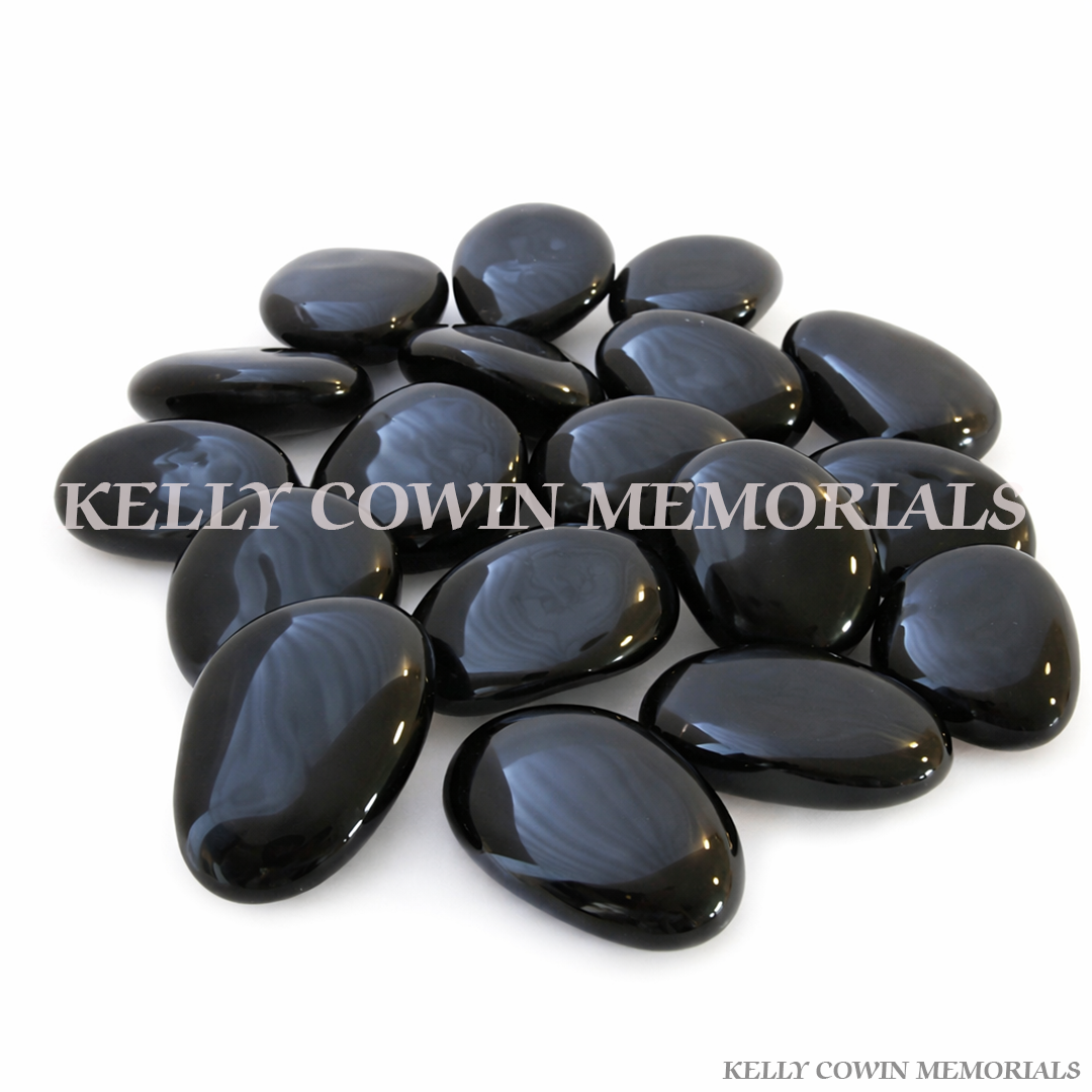Black polished glass pebbles for grave memorial supplied in Dublin by Kelly Cowin Memorials with nationwide delivery across Ireland.