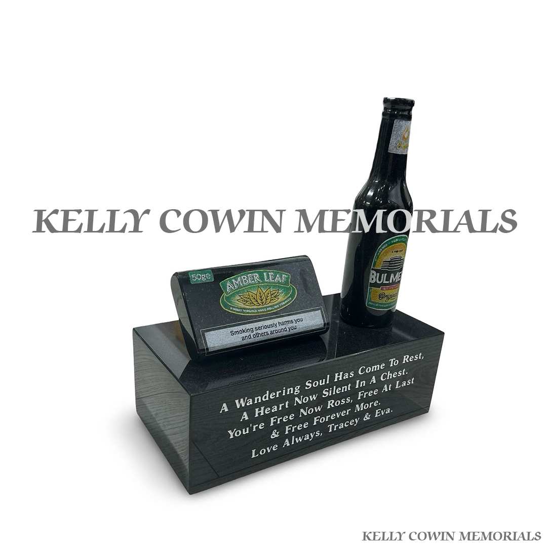 Side view of granite beer bottle and tobacco pouch ornament on plinth
