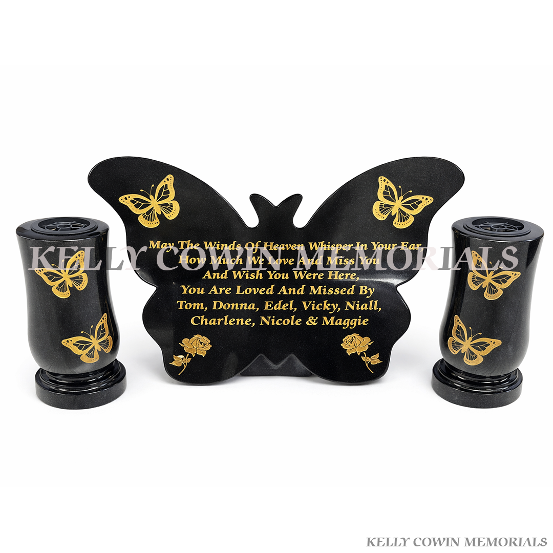 Black granite butterfly shaped memorial plaque with gold inscription and two tall matching memorial vases by Kelly Cowin Memorials Ireland