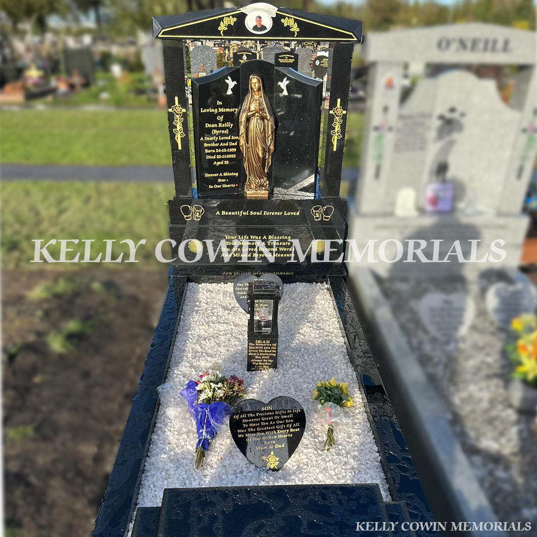Black granite Gates to Heaven memorial with cap and pillars, granite seat, white chippings and gold leaf inscription installed in an Irish cemetery