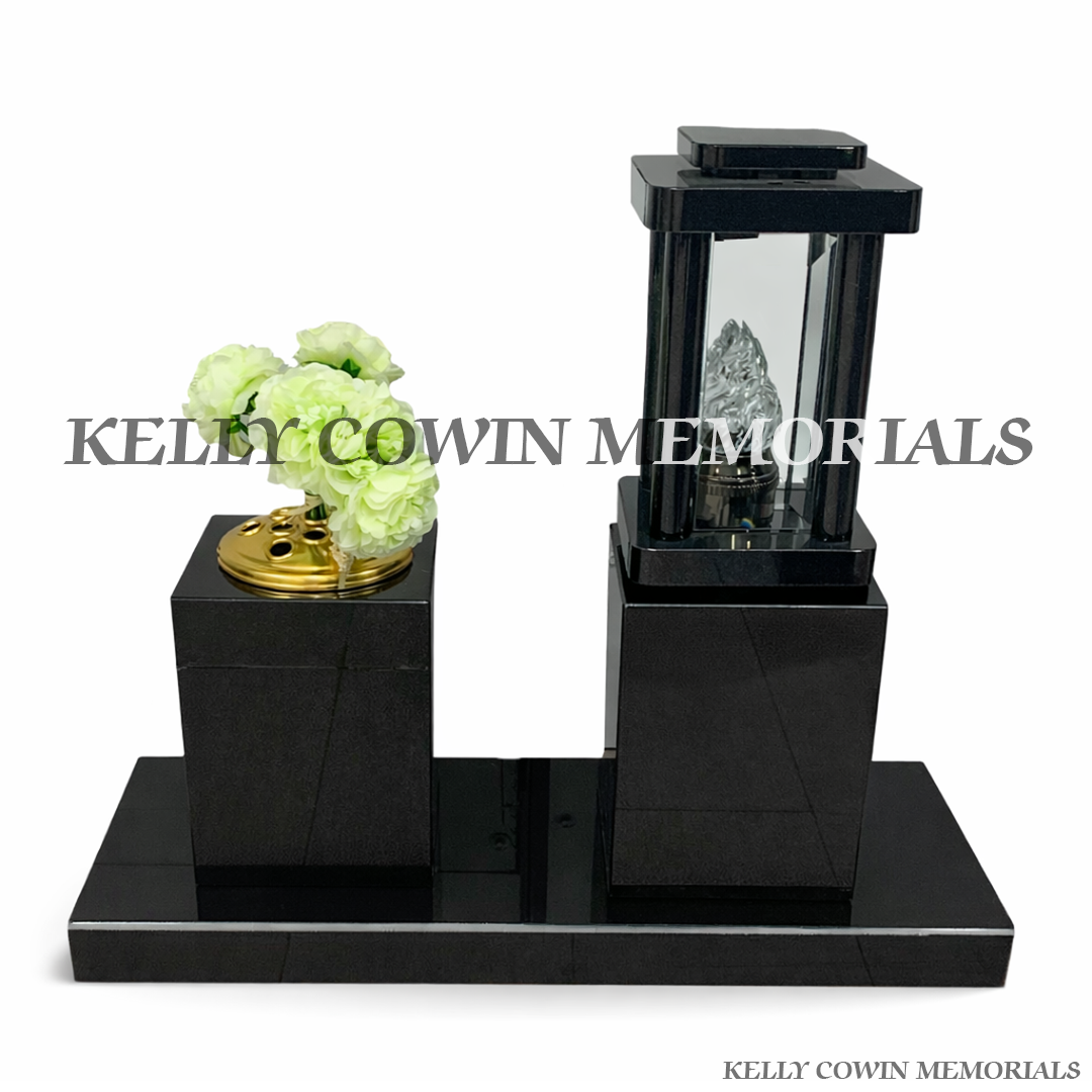 Front view of black granite lantern and square vase set on polished plinth