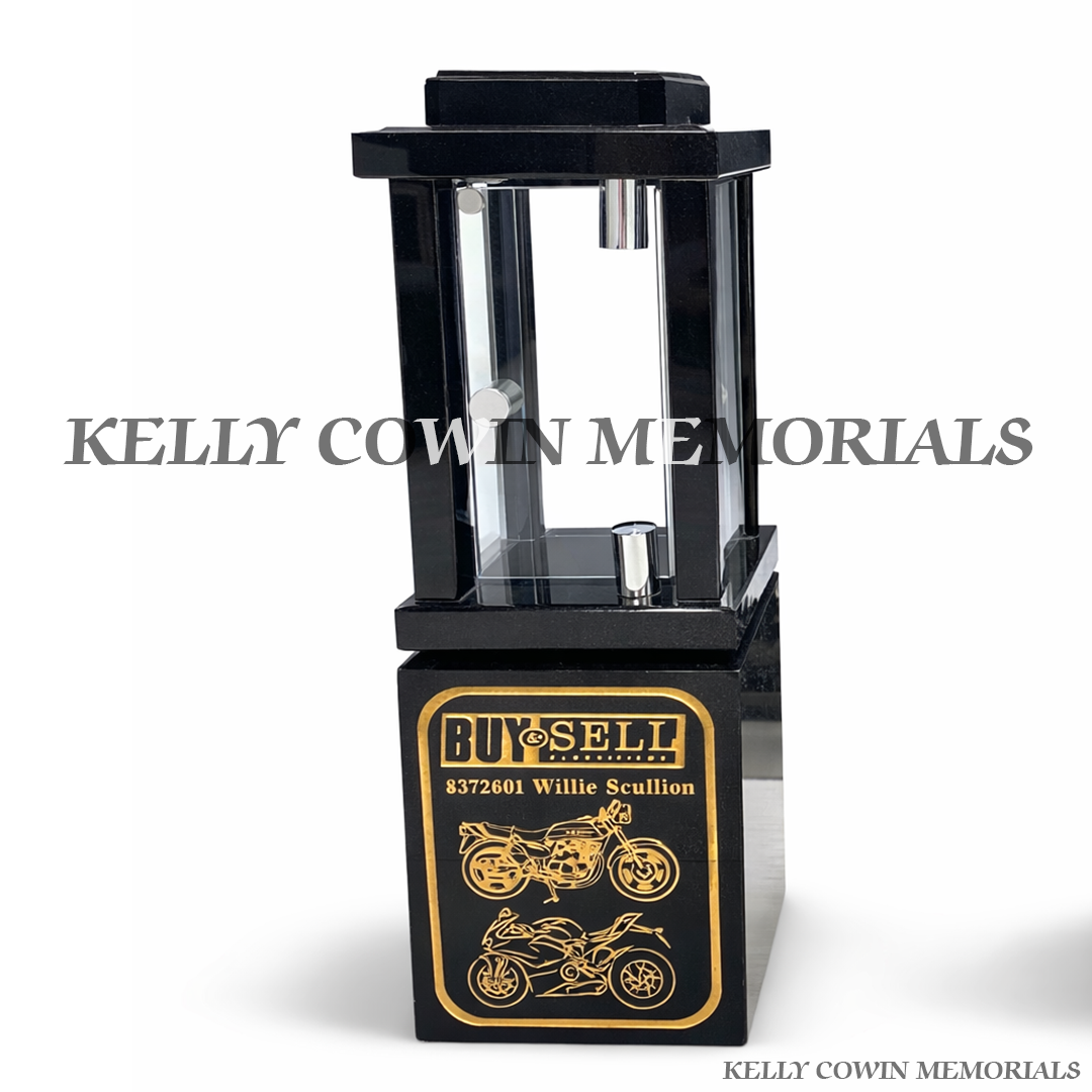 Front view close up of black granite solar lantern with gold engraved motorbikes