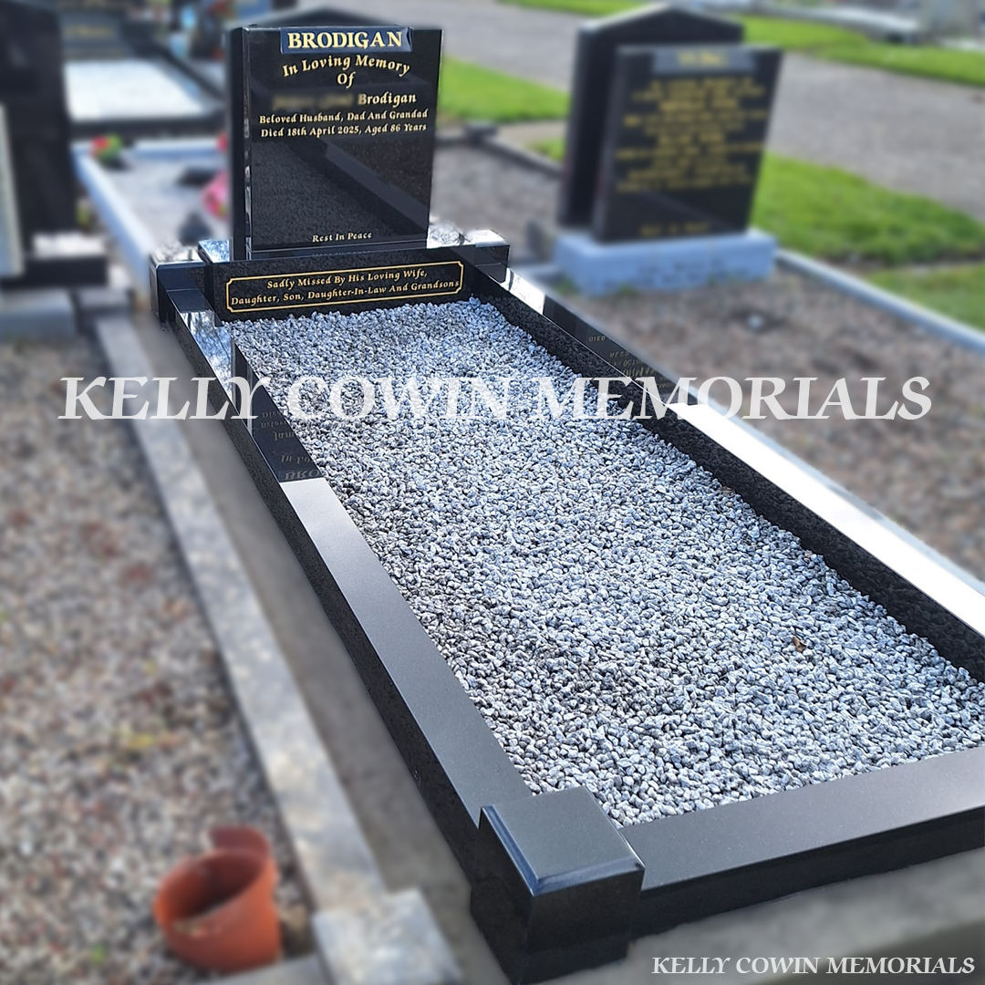 Side view of black granite memorial with kerbing and grey chippings
