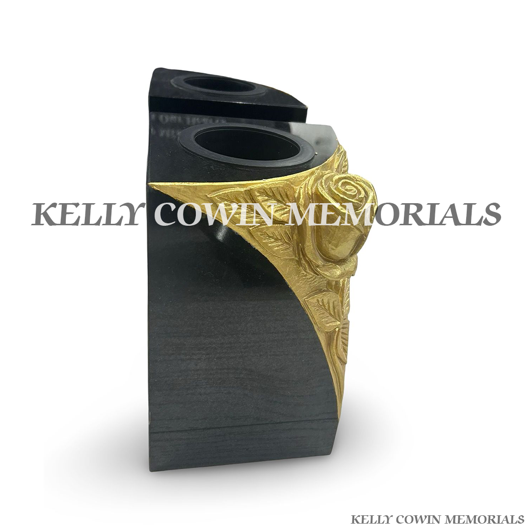 Side view of polished black granite vase with carved rose detail