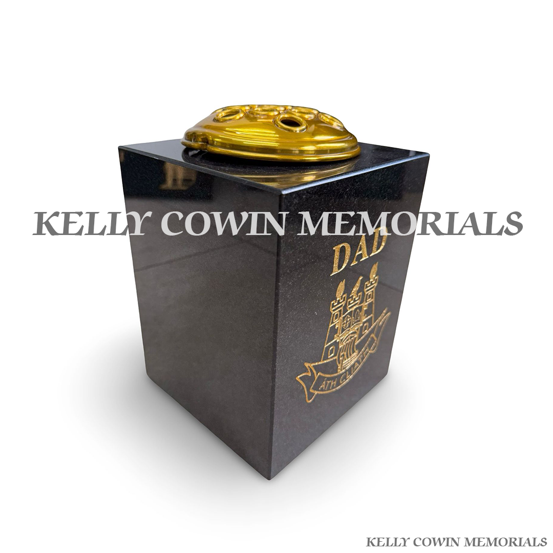 Side view of polished black granite square vase with gold engraving