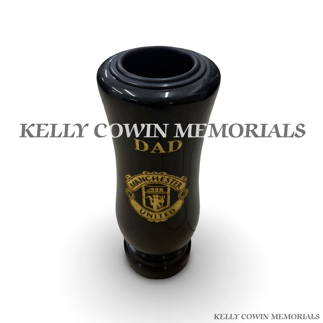 Close-up of gold engraving showing Manchester United crest and Dad wording