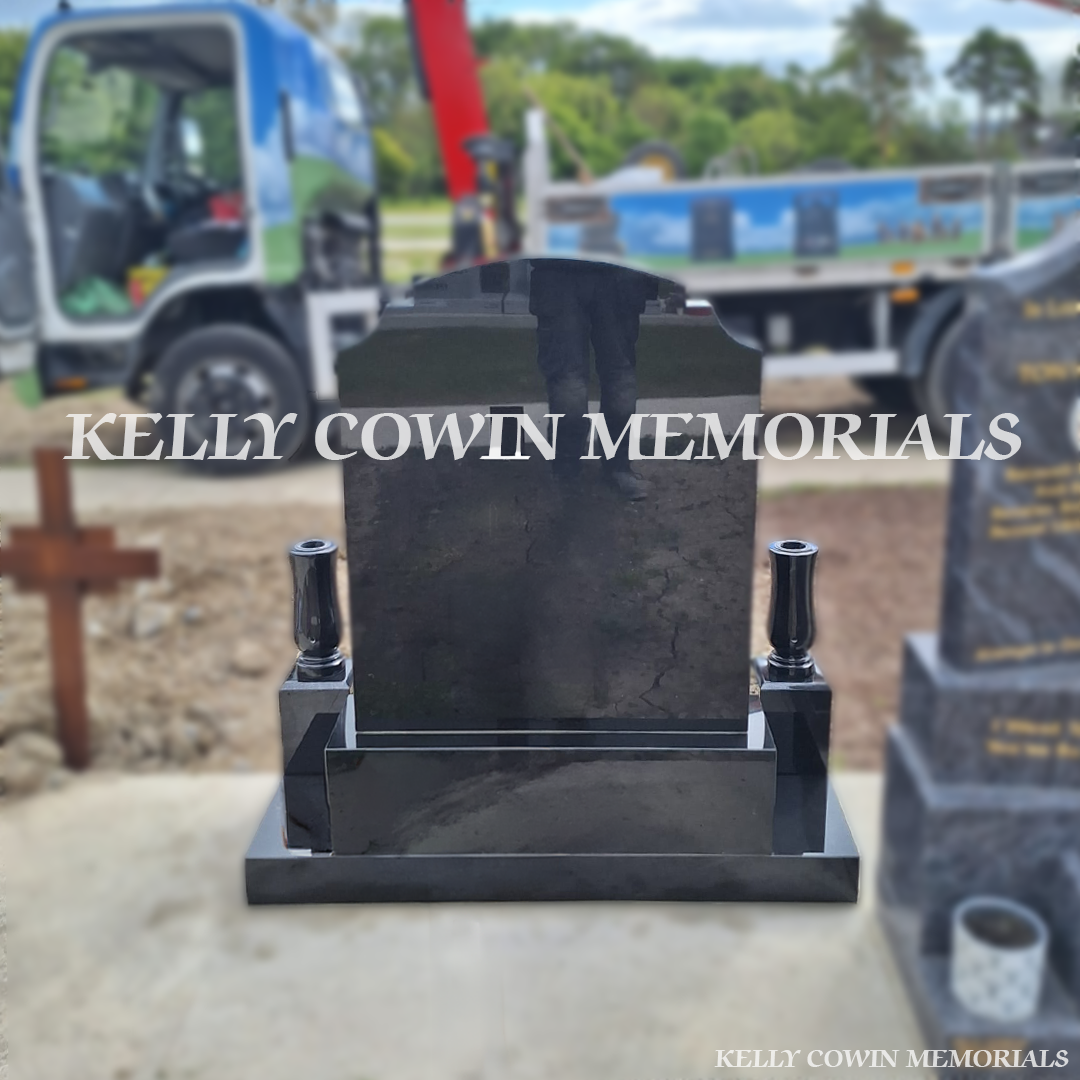 Back view of black granite Top Nine headstone with gold lettering in Balgriffin Cemetery