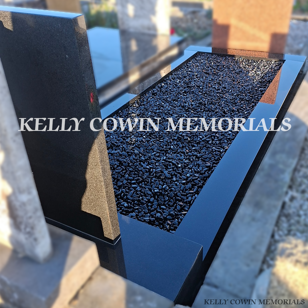 Back side view of black granite memorial with kerbing and black chippings