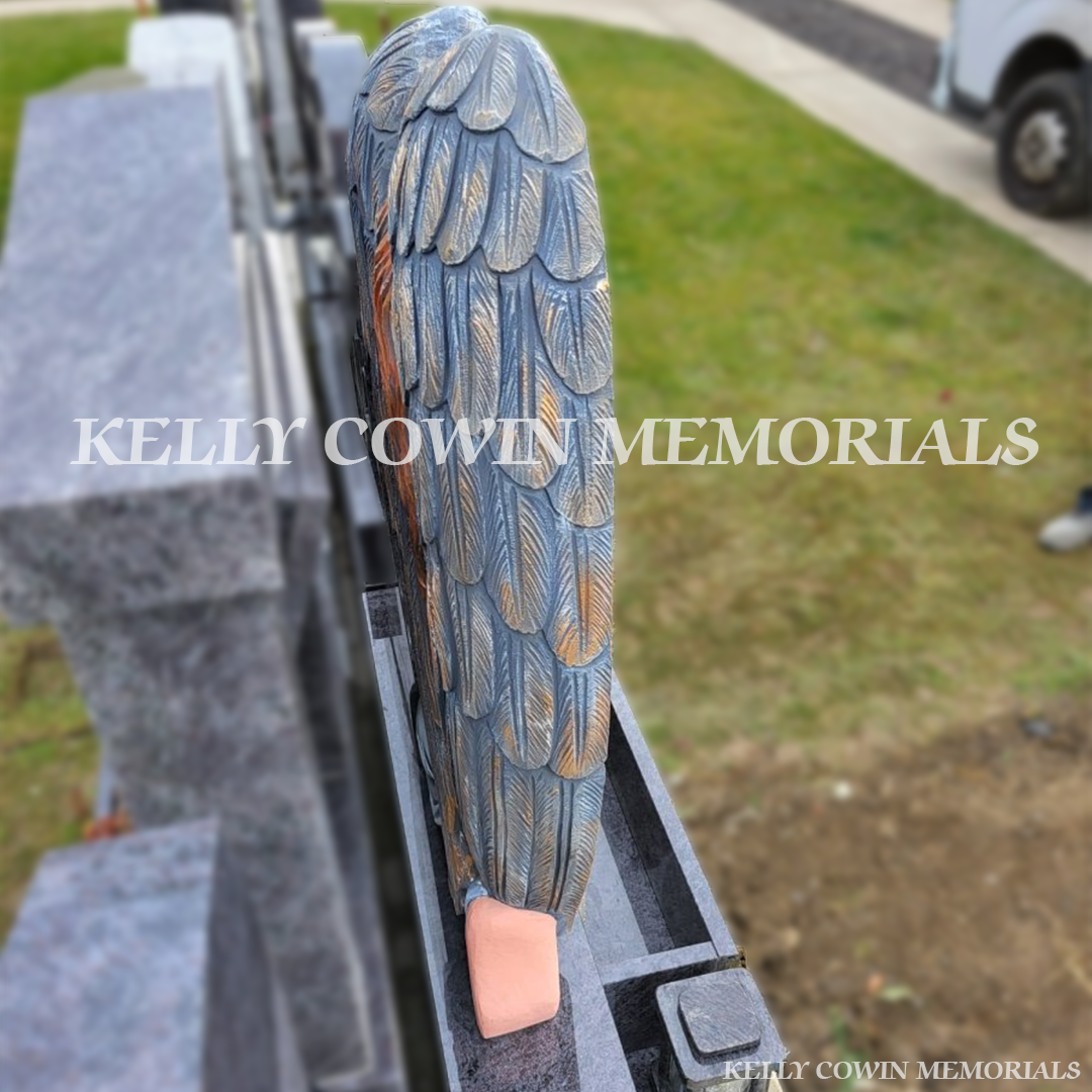 Side view of Blue Lagoon angel headstone with carved figure in Balgriffin Cemetery Dublin