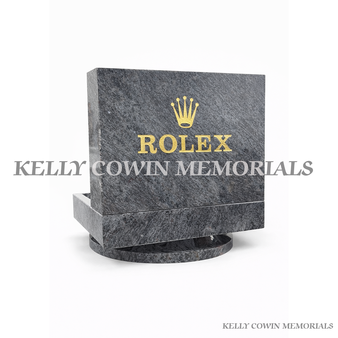 Gray granite headstone with Rolex logo on a white background, branded 'Kelly Cowin Memorials'.