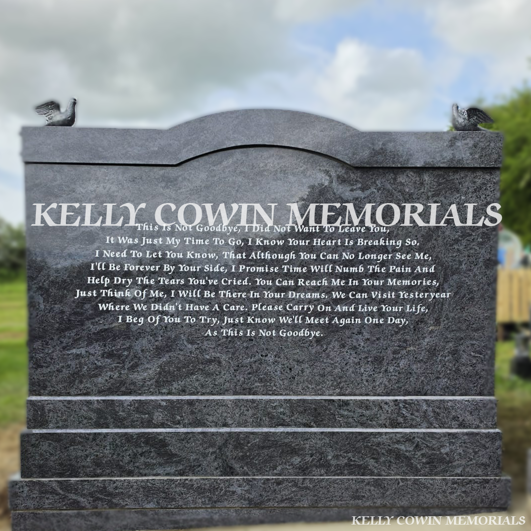 Back view of Blue Lagoon custom memorial with twisted pillars and silver statues in Cork cemetery