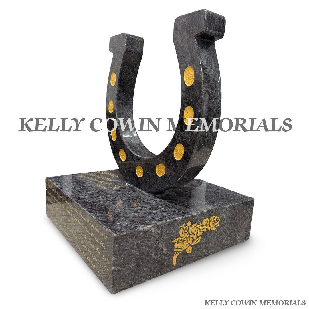 Side view of polished Blue Lagoon granite horseshoe ornament with gold wording