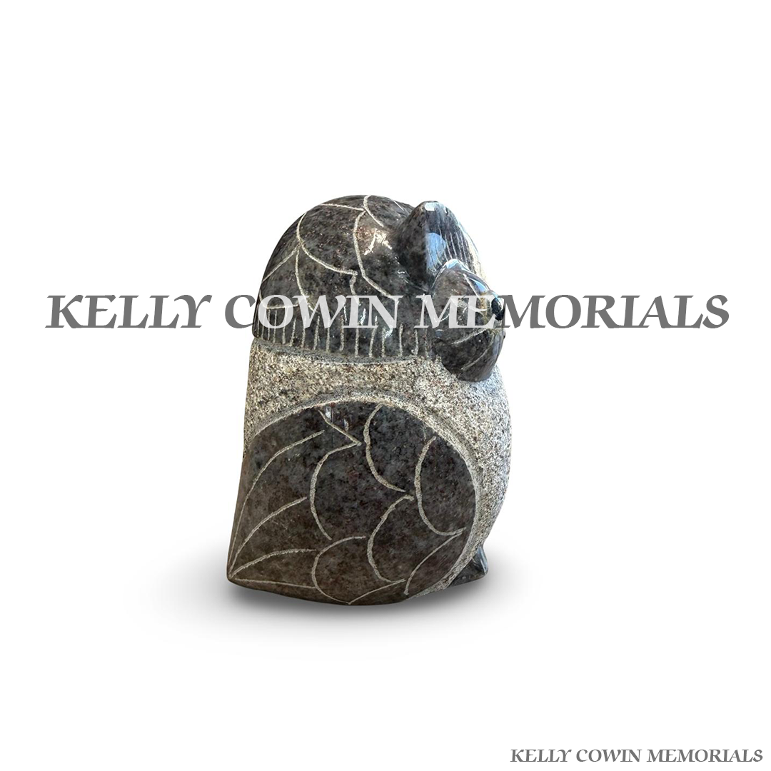 Side view of polished Blue Lagoon granite owl ornament