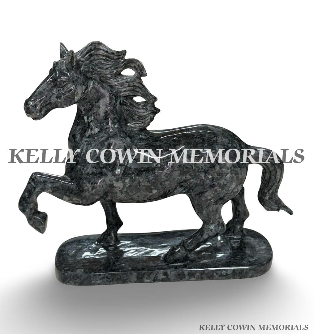 Side view of carved granite horse memorial ornament showing detailed mane, body, legs and tail.