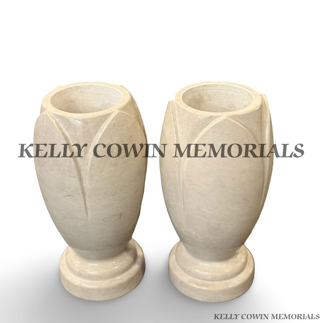 Pair of custom large Haley Beige granite memorial flower vases with polished finish and carved detailing by Kelly Cowin Memorials.
