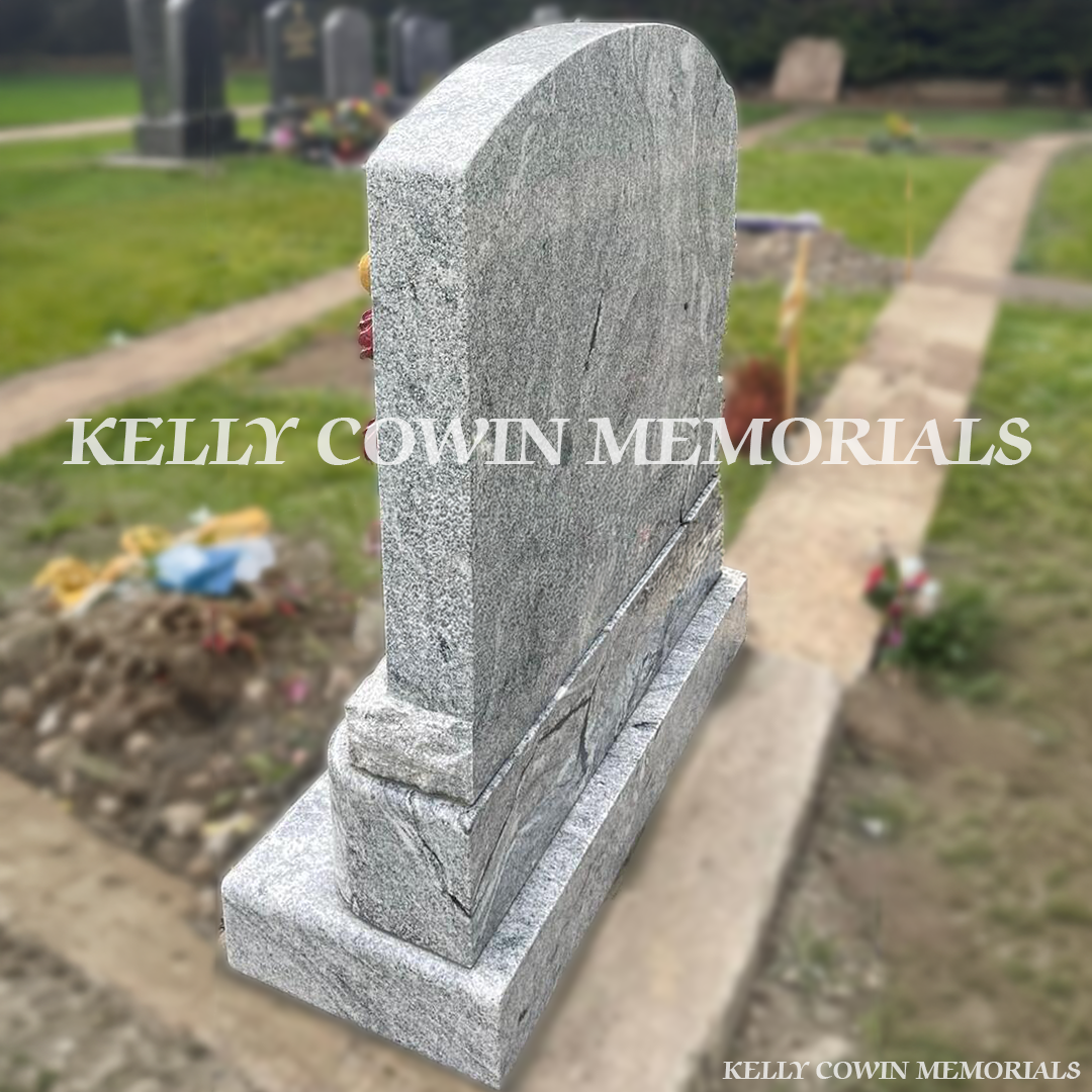 Rear view of custom grey granite angel memorial installed by Kelly Cowin Memorials in a Dublin cemetery