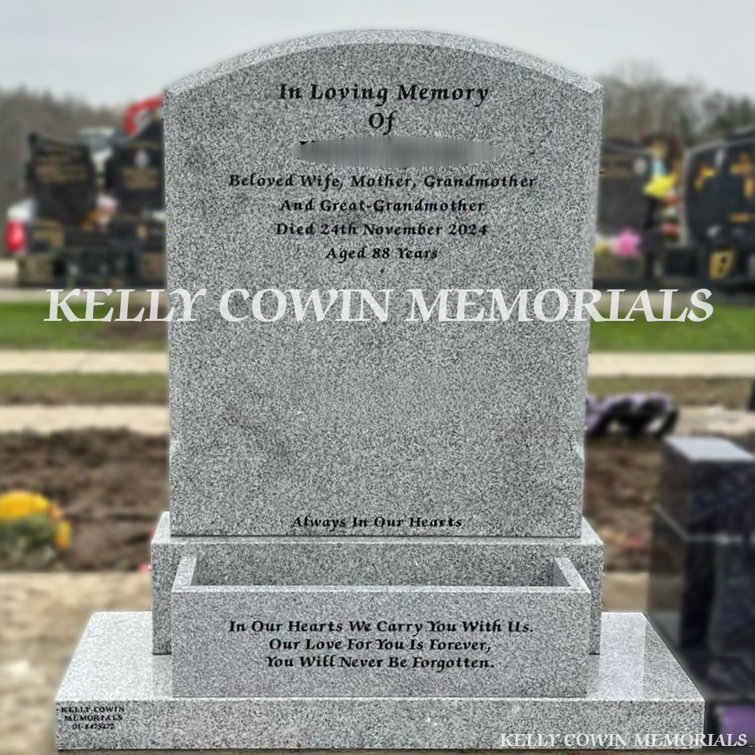 Front view of Grey Granite polished boulder headstone with black inscription and flower box in Bohernabreena Cemetery Dublin