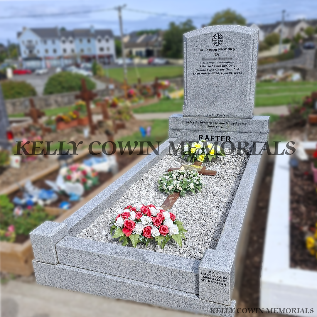 Grey granite polished boulder headstone with carved rope and tassel detailing, full kerbing, corner posts and white Moldovan chippings in Balrothery Cemetery.