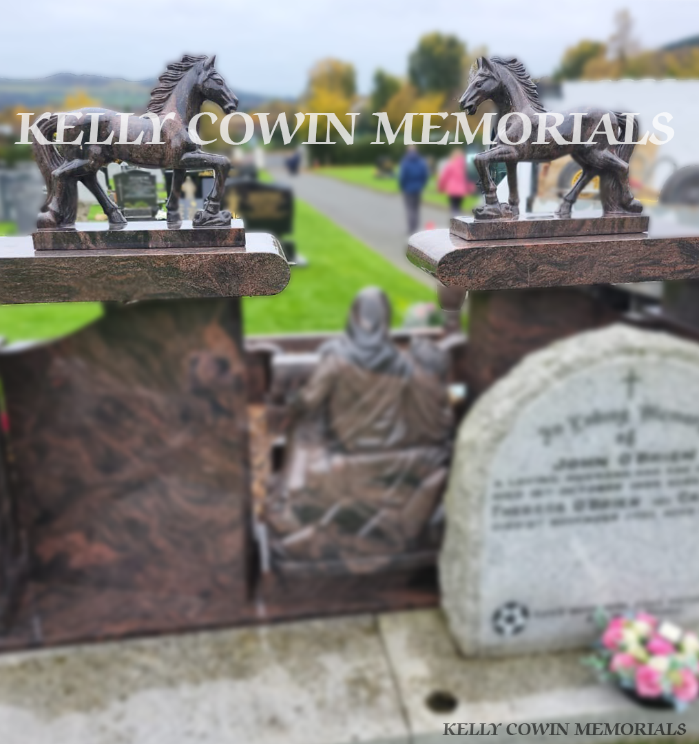 Two Pandora granite horse statues displayed on a memorial headstone in an Irish cemetery.