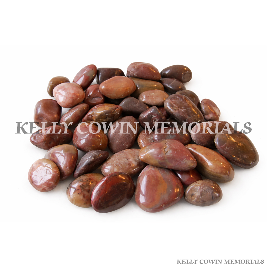 Red polished cobbles for grave memorial supplied in Dublin by Kelly Cowin Memorials with nationwide delivery across Ireland.