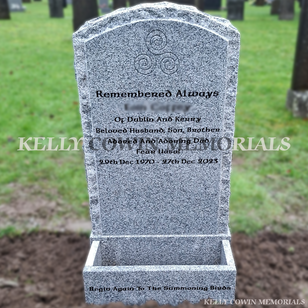 Front view Grey granite rough boulder headstone with flower box and black inscription in Glasnevin Cemetery Dublin by Kelly Cowin Memorials