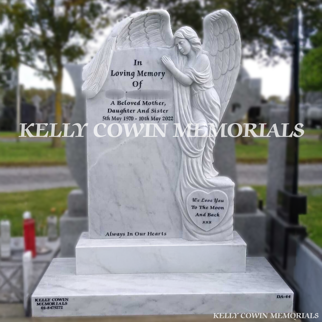 Front view of white marble angel headstone with black inscription on base and plinth in Dardistown Cemetery Dublin