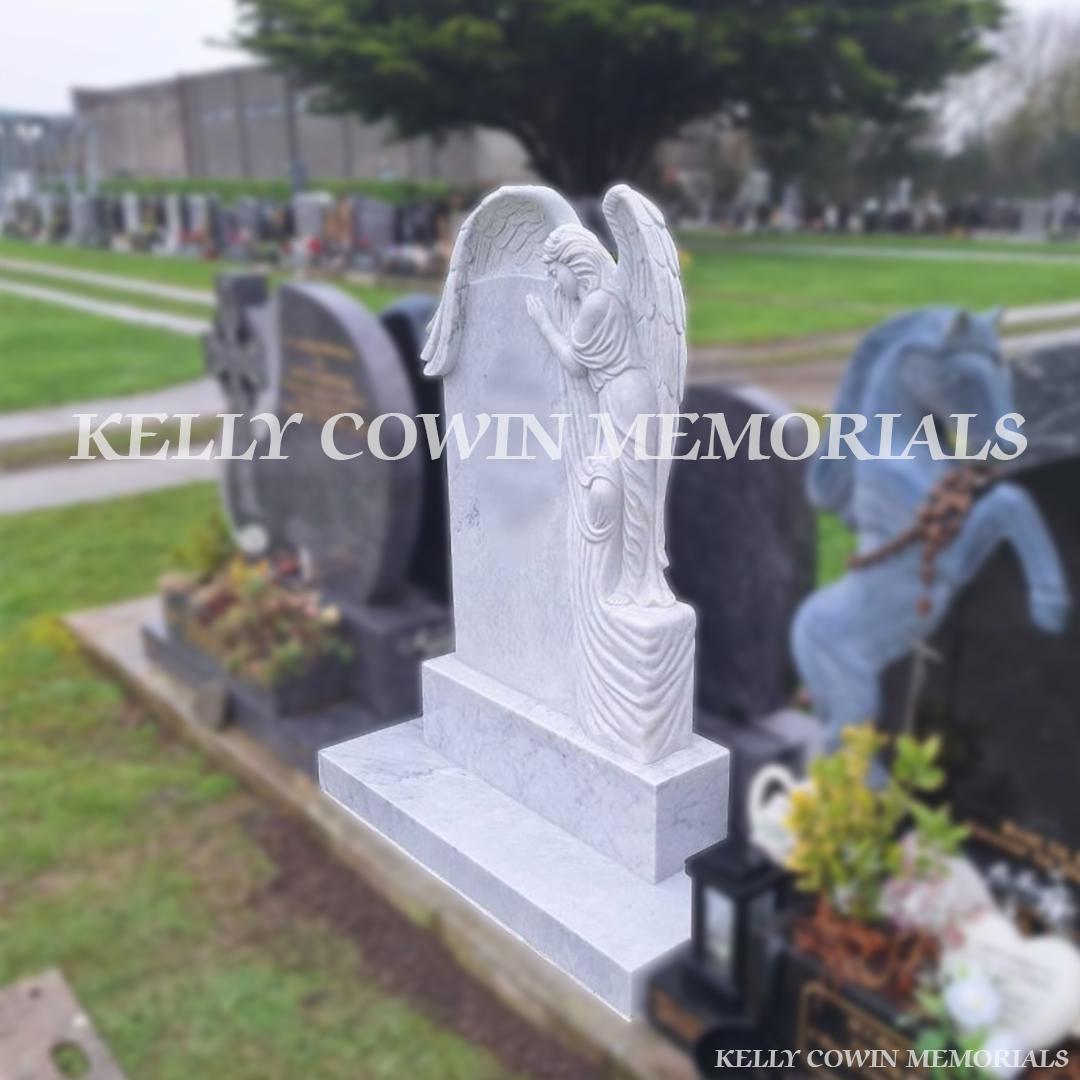 Side view of white marble angel headstone with carved figure in Balgriffin Cemetery Dublin