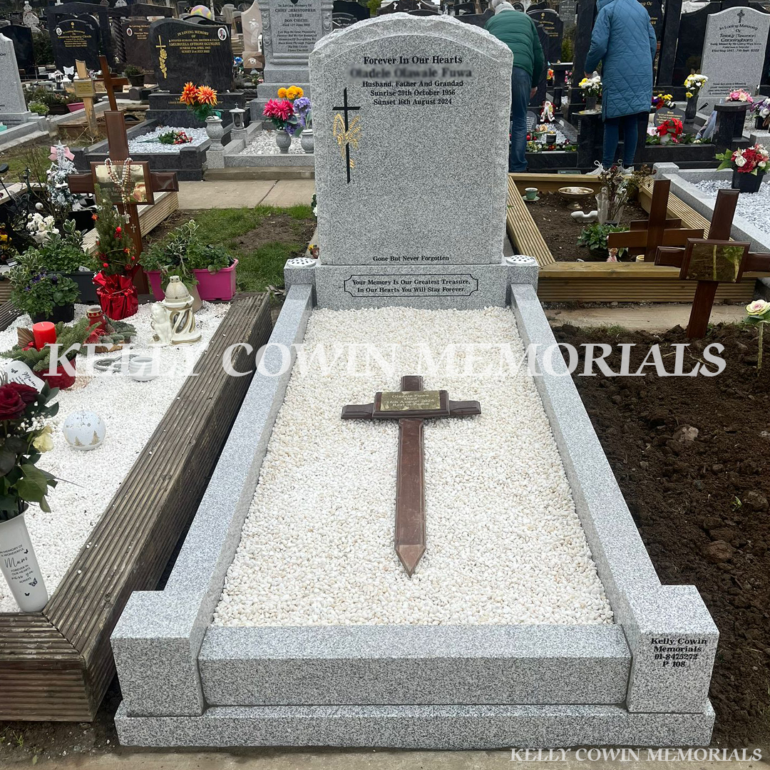 Grey granite rough boulder headstone with kerbing installed in Mulhuddart Cemetery by Kelly Cowin Memorials