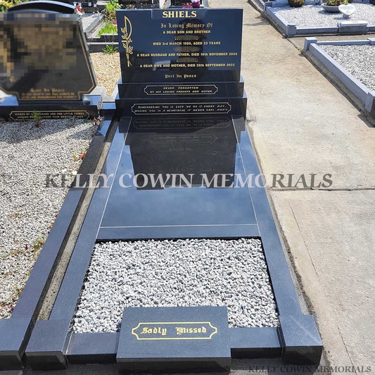 after gravestone renovation in Fingal Cemetery showing black granite covering slab installation with garden planting area by Kelly Cowin Memorials
