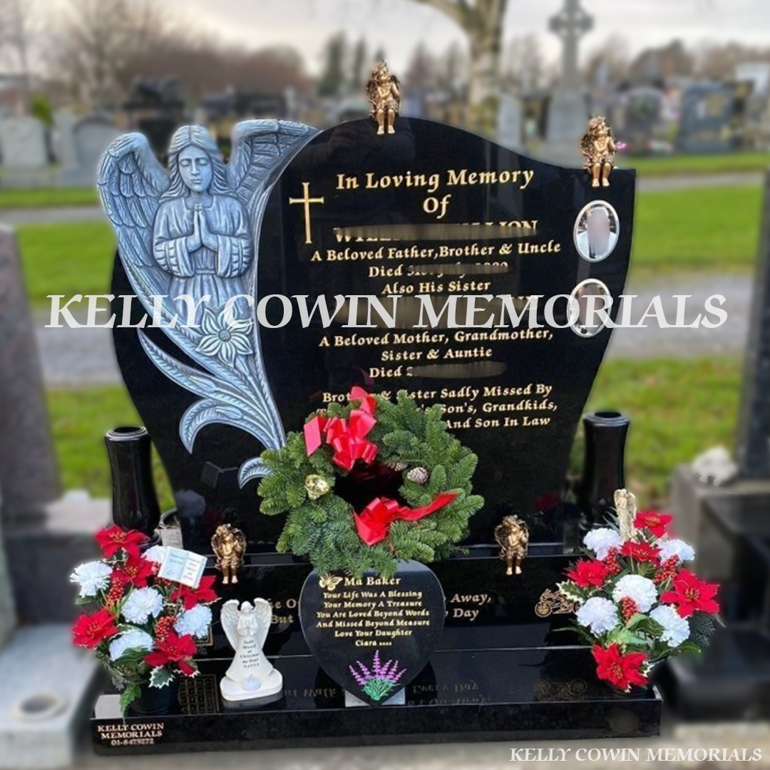 Front view of black granite antique carved angel headstone with gold inscription and bronze angel details in Dardistown Cemetery Dublin