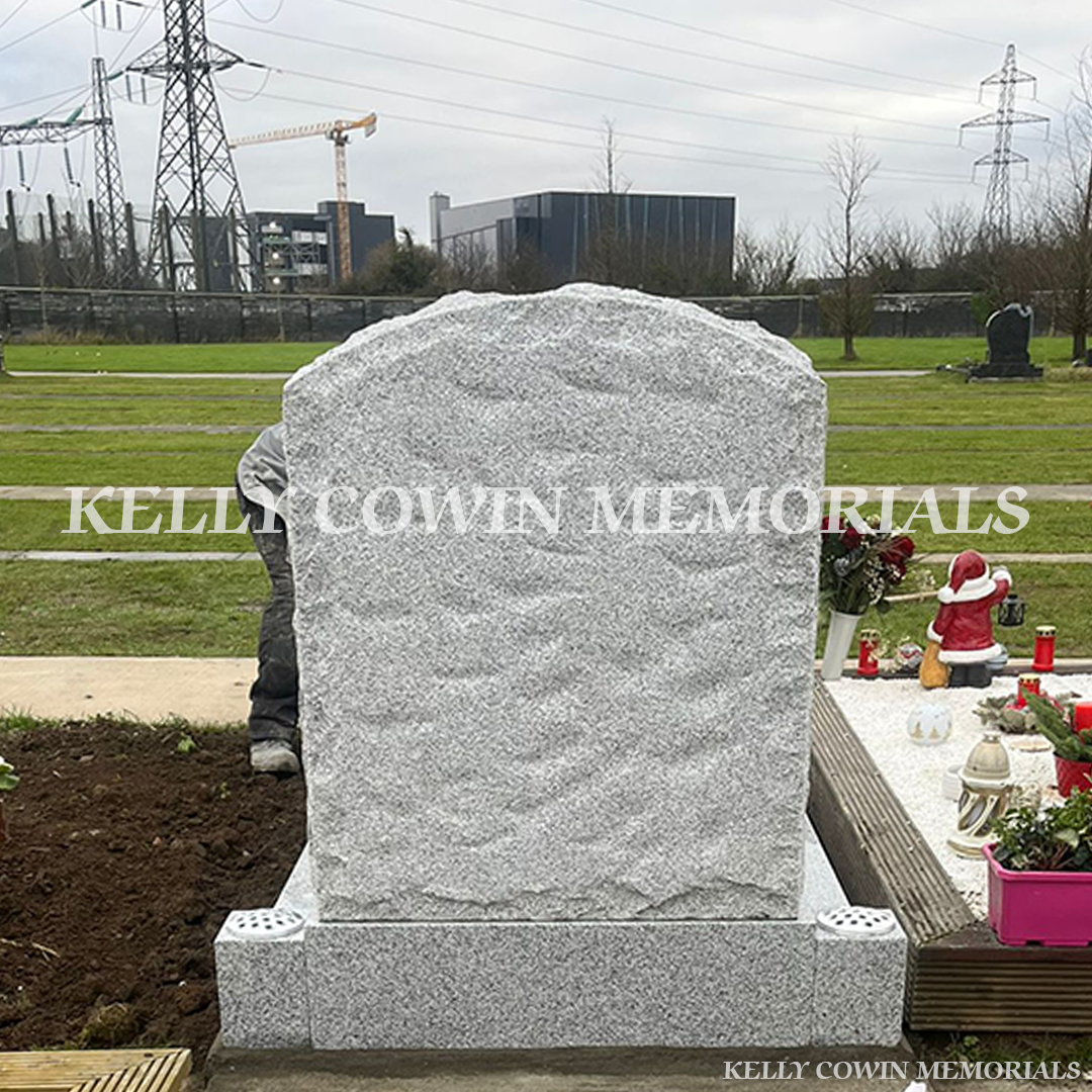 Grey granite rough boulder headstone with kerbing installed in Mulhuddart Cemetery by Kelly Cowin Memorials