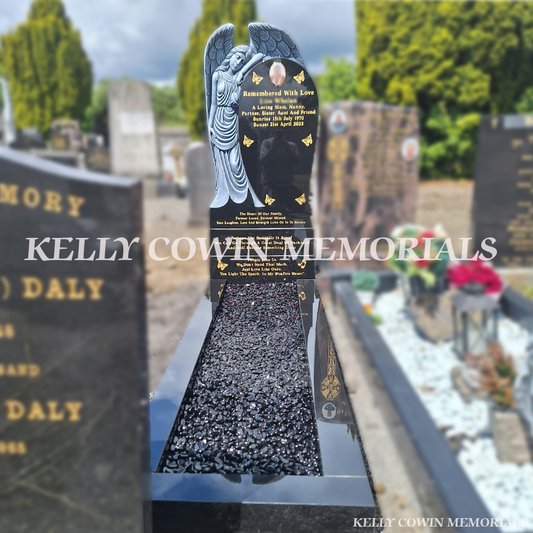 Black Granite Angel headstone with carved angel sculpture, polished granite kerbing, black decorative chippings and gold leaf inscription installed in Glasnevin Cemetery by Kelly Cowin Memorials.
