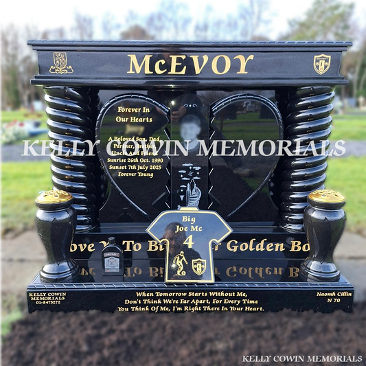 a black granite broken heart headstone with twisted pillars and gold leaf inscription, installed by Kelly Cowin Memorials in Newlands Cross Cemetery, Dublin.