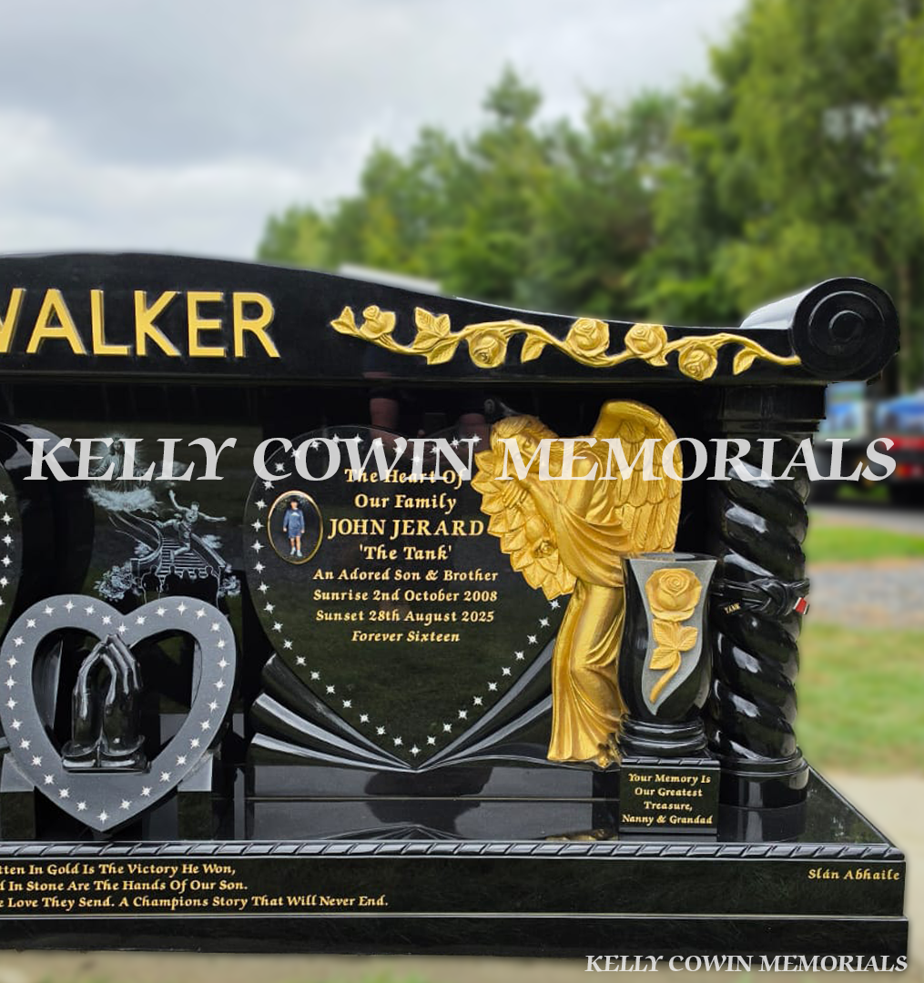 Gold rose-carved angel beside heart-shaped inscription panel on bespoke black granite headstone in Dublin.