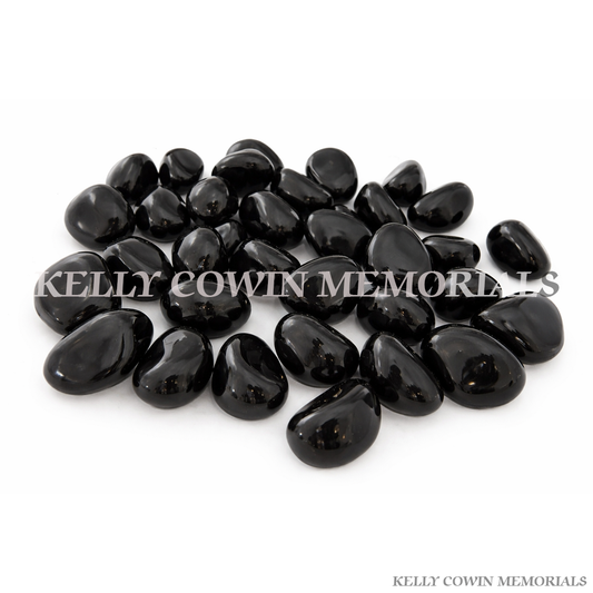 Black polished glass pebbles for grave memorial supplied in Dublin by Kelly Cowin Memorials with nationwide delivery across Ireland.