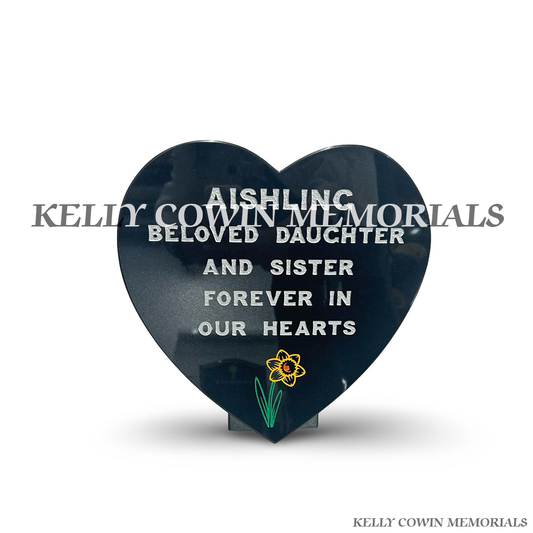 Front view of black granite heart plaque with silver inscription and daffodil image