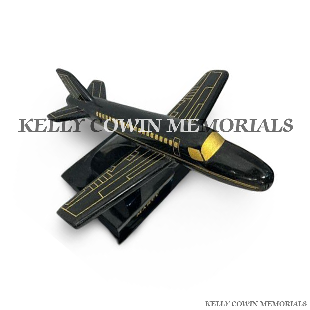 Side view of polished black granite aeroplane ornament with gold inscription