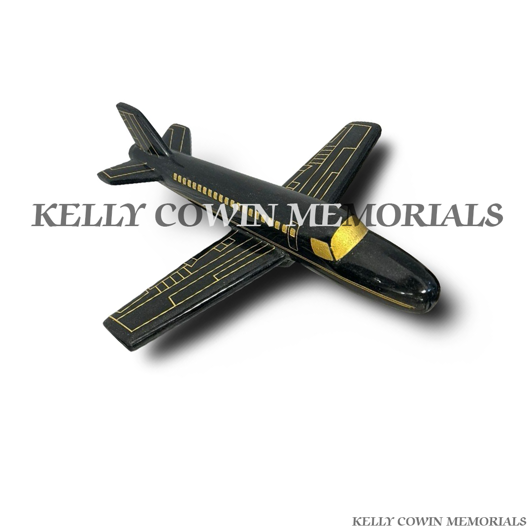 Side view of polished black granite aeroplane ornament with gold inscription