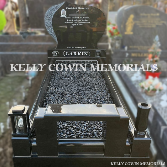 Front view of custom black granite headstone with carved flowers and white inscription in Fingal Cemetery Dublin