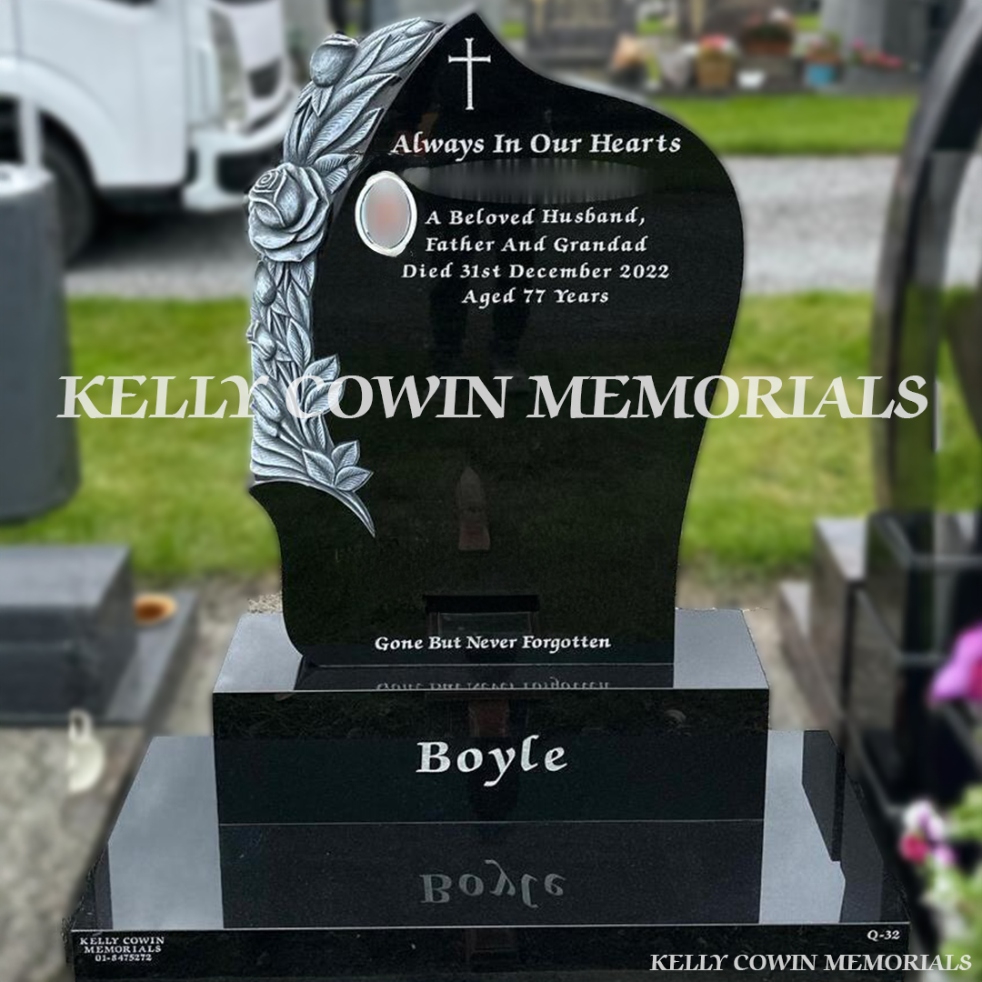 Front view of black granite headstone with antique carved roses and silver inscription in Dardistown Cemetery Dublin