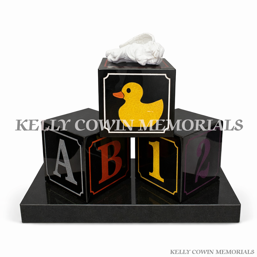 Black granite baby blocks grave accessory with personalised engraving and baby-themed artwork, made in Ireland by Kelly Cowin Memorials
