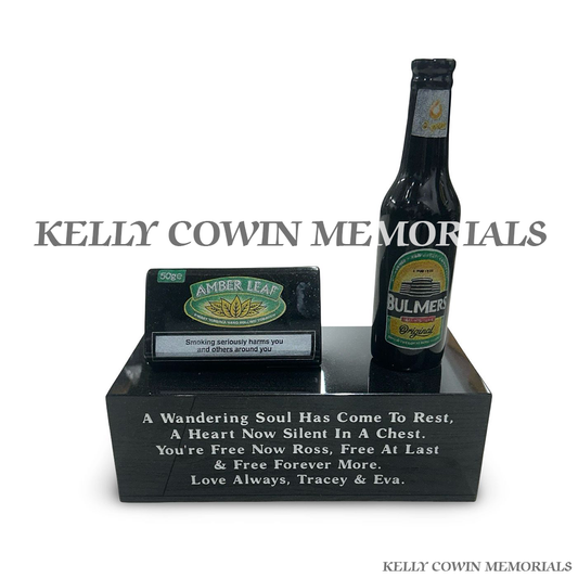 Front view of black granite Bulmers bottle and tobacco pouch memorial