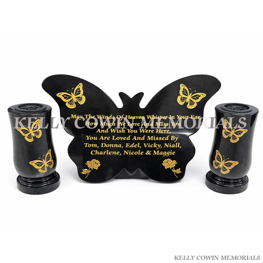 Black granite butterfly shaped memorial plaque with gold inscription and two tall matching memorial vases by Kelly Cowin Memorials Ireland