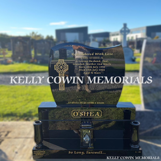 Black granite C1 headstone with curved top and no cut-outs, gold Celtic cross engraving, matching sub-base, base, plinth, two granite vases and central solar lantern, erected in Dardistown Cemetery, Dublin, by Kelly Cowin Memorials.