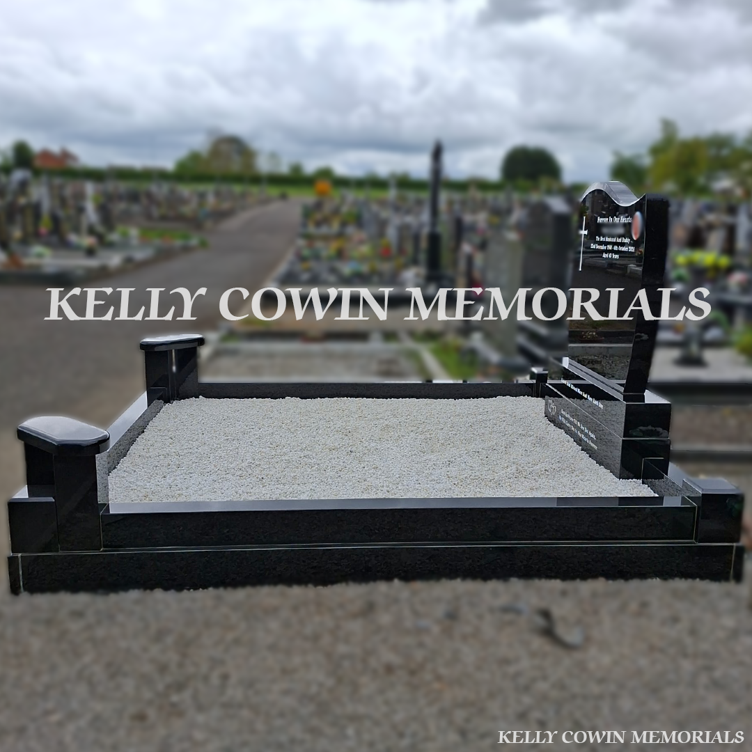 Side view of black granite memorial with kerbing and white chippings
