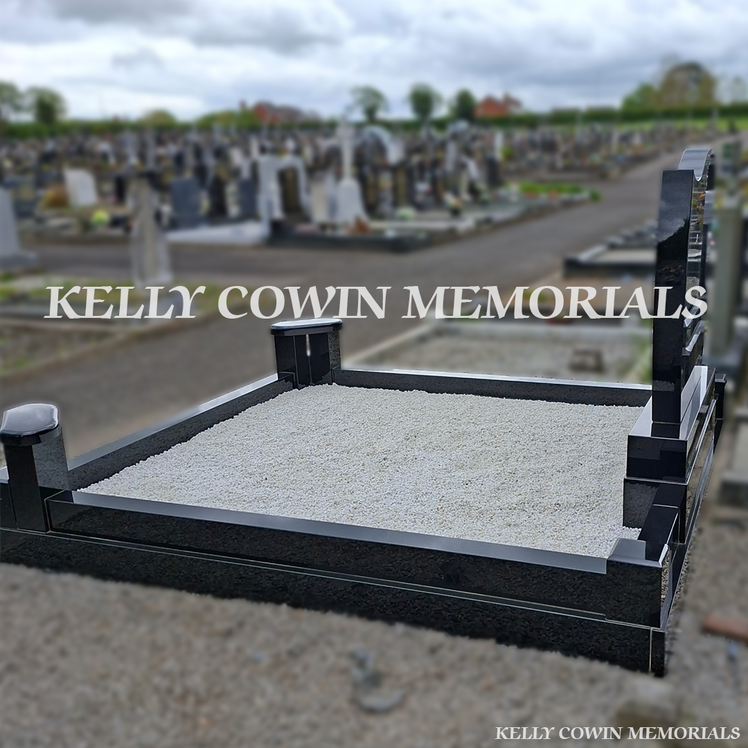 Side view of black granite memorial with kerbing and white chippings