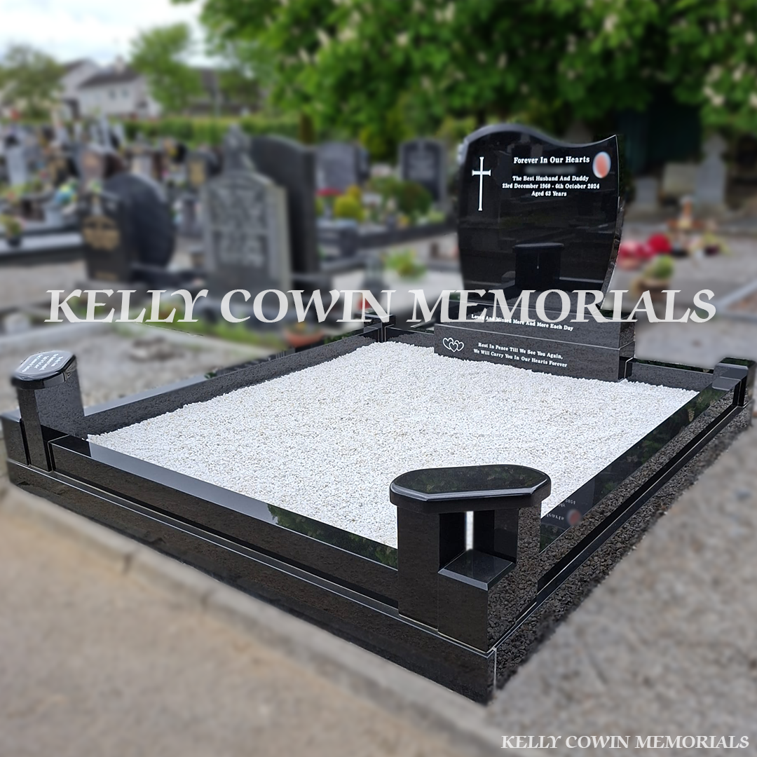 Side view of black granite memorial with kerbing and white chippings